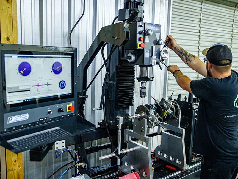 Operator balancing a crankshaft on a ProBal balancing machine